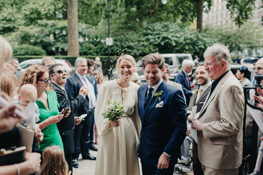 Bride Jess wears an original 1970's vintage Ossie Clarke dress for her Jewish wedding ceremony at Home House in London. Photography by Rebecca Goddard.