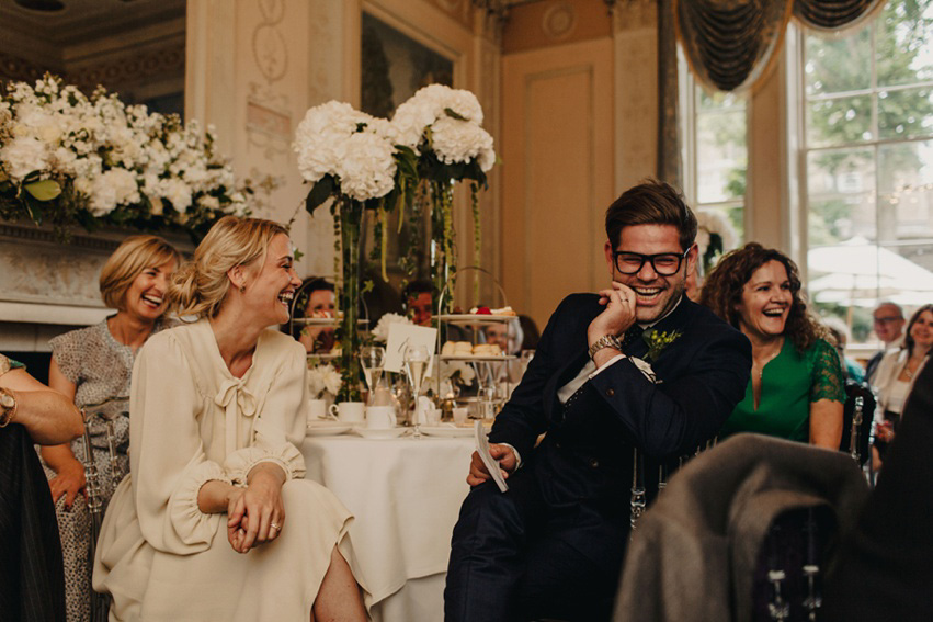 Bride Jess wears an original 1970's vintage Ossie Clarke dress for her Jewish wedding ceremony at Home House in London. Photography by Rebecca Goddard.