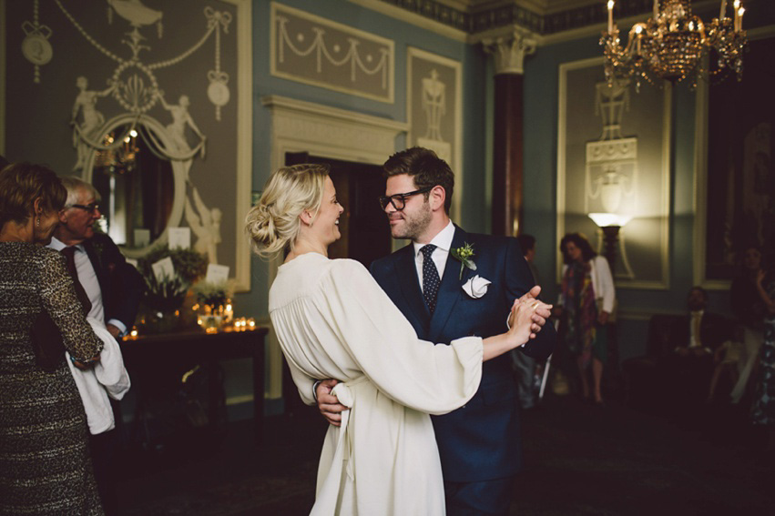 Bride Jess wears an original 1970's vintage Ossie Clarke dress for her Jewish wedding ceremony at Home House in London. Photography by Rebecca Goddard.