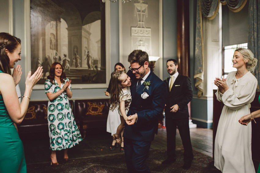 Bride Jess wears an original 1970's vintage Ossie Clarke dress for her Jewish wedding ceremony at Home House in London. Photography by Rebecca Goddard.