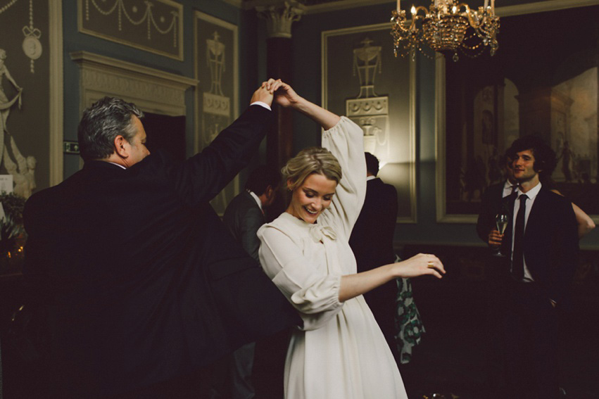 Bride Jess wears an original 1970's vintage Ossie Clarke dress for her Jewish wedding ceremony at Home House in London. Photography by Rebecca Goddard.