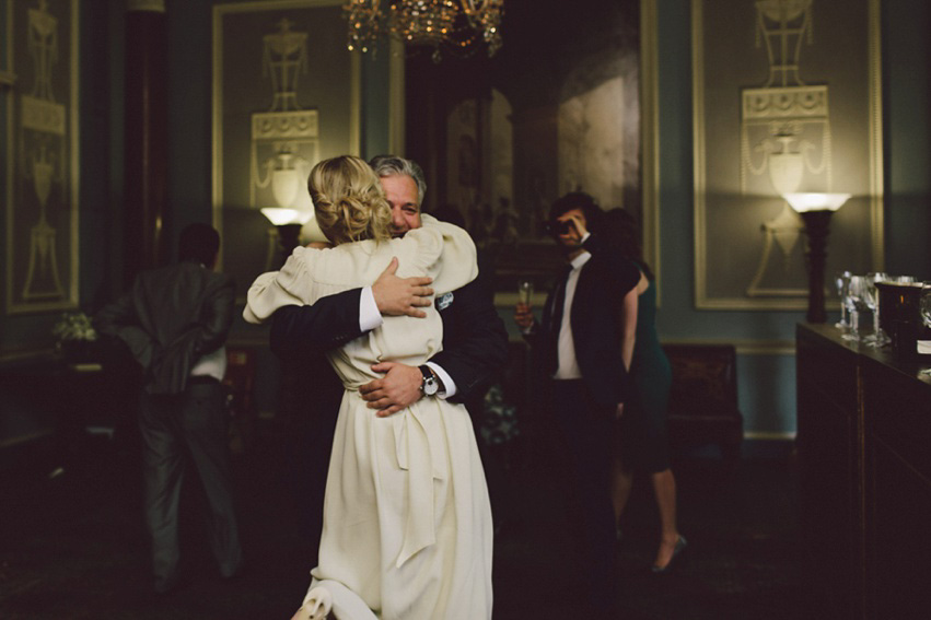 Bride Jess wears an original 1970's vintage Ossie Clarke dress for her Jewish wedding ceremony at Home House in London. Photography by Rebecca Goddard.