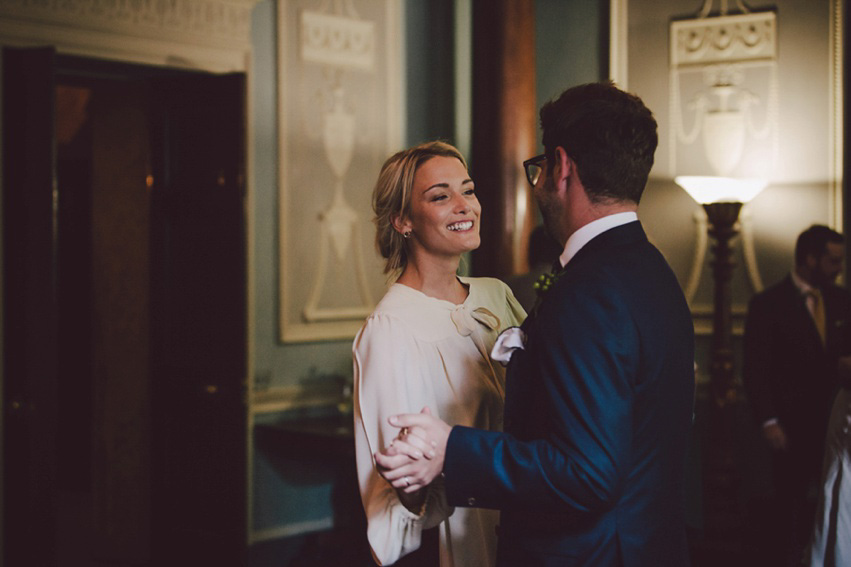 Bride Jess wears an original 1970's vintage Ossie Clarke dress for her Jewish wedding ceremony at Home House in London. Photography by Rebecca Goddard.