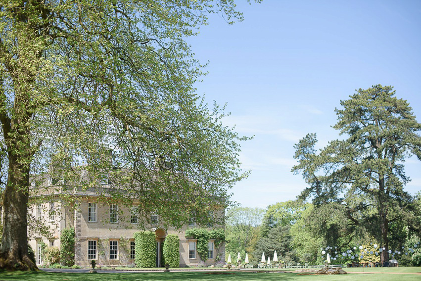 A Theia Couture wedding dress and ostrich feathers for this elegant Babington House wedding. Photography by Ria Mishaal.