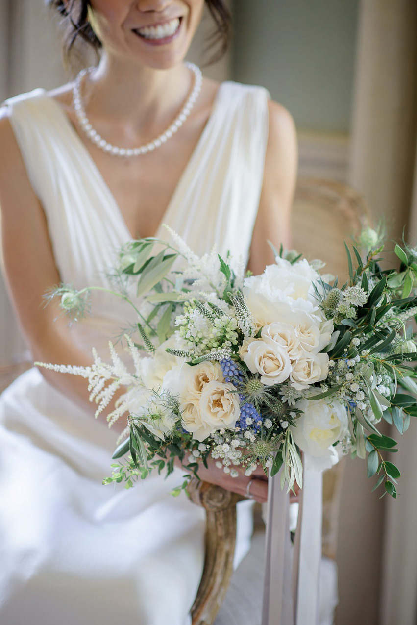 A Theia Couture wedding dress and ostrich feathers for this elegant Babington House wedding. Photography by Ria Mishaal.