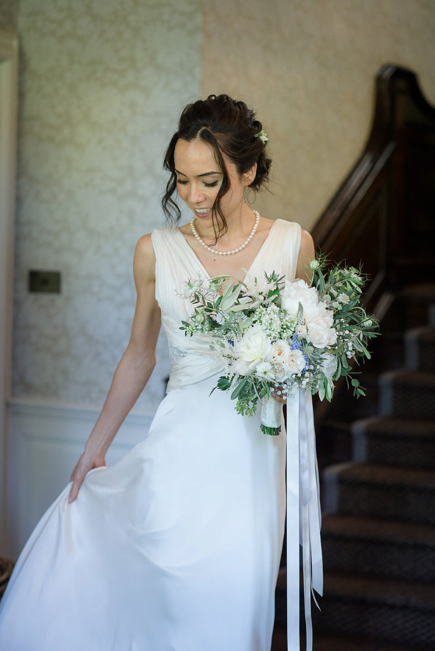 A Theia Couture wedding dress and ostrich feathers for this elegant Babington House wedding. Photography by Ria Mishaal.