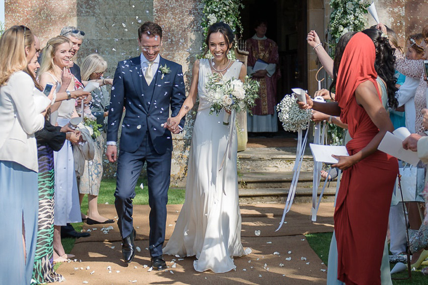 A Theia Couture wedding dress and ostrich feathers for this elegant Babington House wedding. Photography by Ria Mishaal.