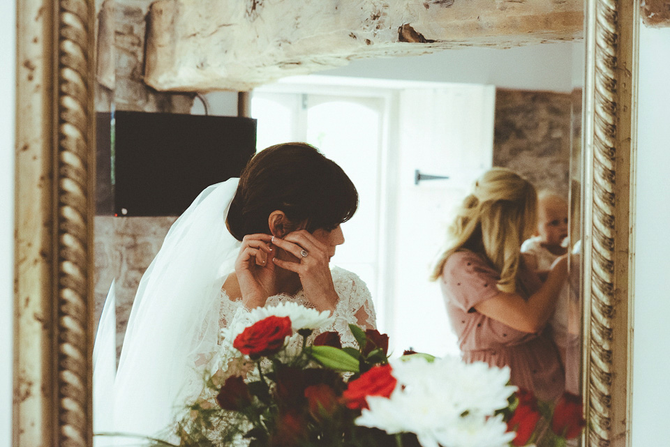 The bride wears a 1950's inspired lace dress for her village hall wedding in Yorkshire. Photography by Shutter Go Click.