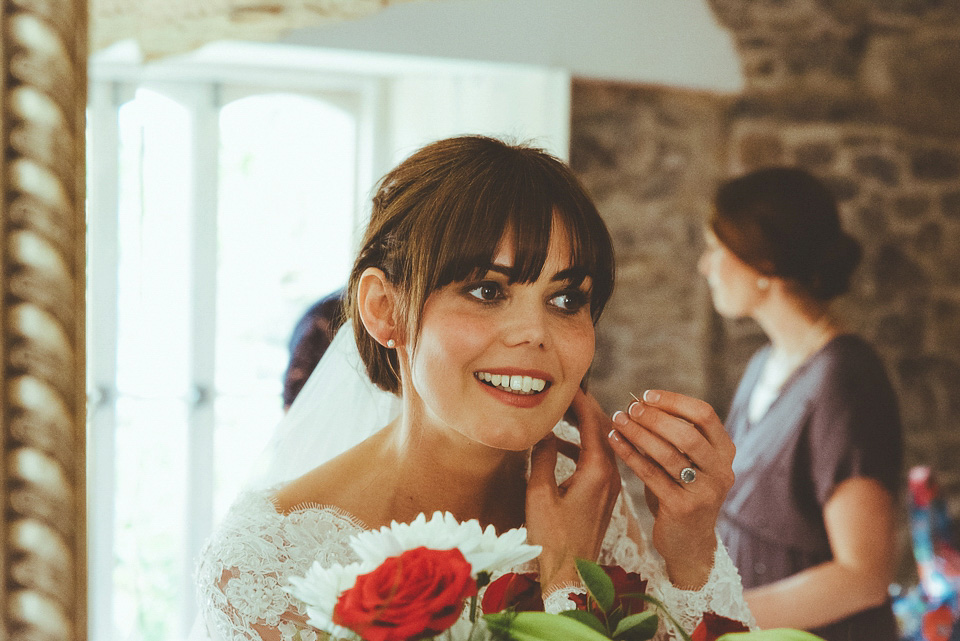 The bride wears a 1950's inspired lace dress for her village hall wedding in Yorkshire. Photography by Shutter Go Click.