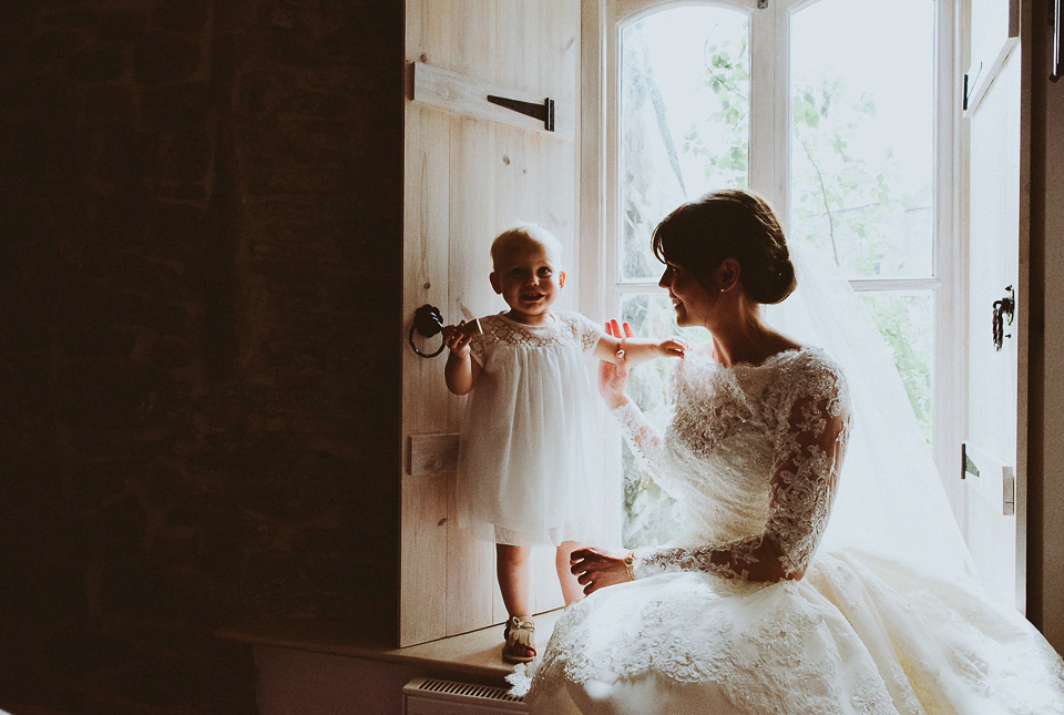 The bride wears a 1950's inspired lace dress for her village hall wedding in Yorkshire. Photography by Shutter Go Click.