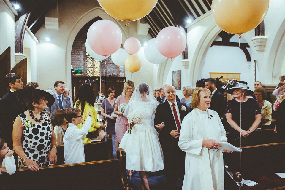 The bride wears a 1950's inspired lace dress for her village hall wedding in Yorkshire. Photography by Shutter Go Click.