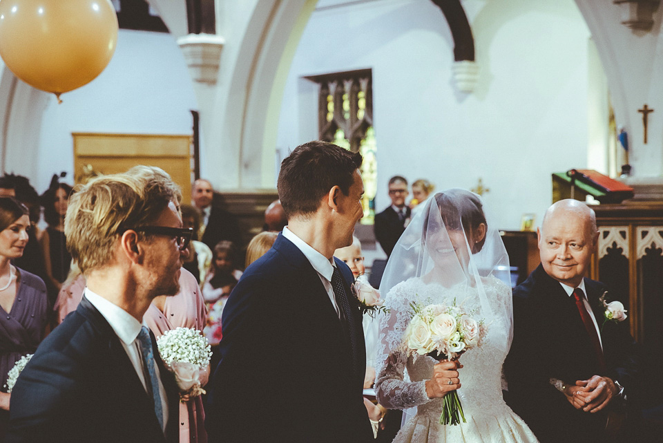 The bride wears a 1950's inspired lace dress for her village hall wedding in Yorkshire. Photography by Shutter Go Click.