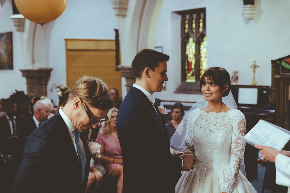 The bride wears a 1950's inspired lace dress for her village hall wedding in Yorkshire. Photography by Shutter Go Click.