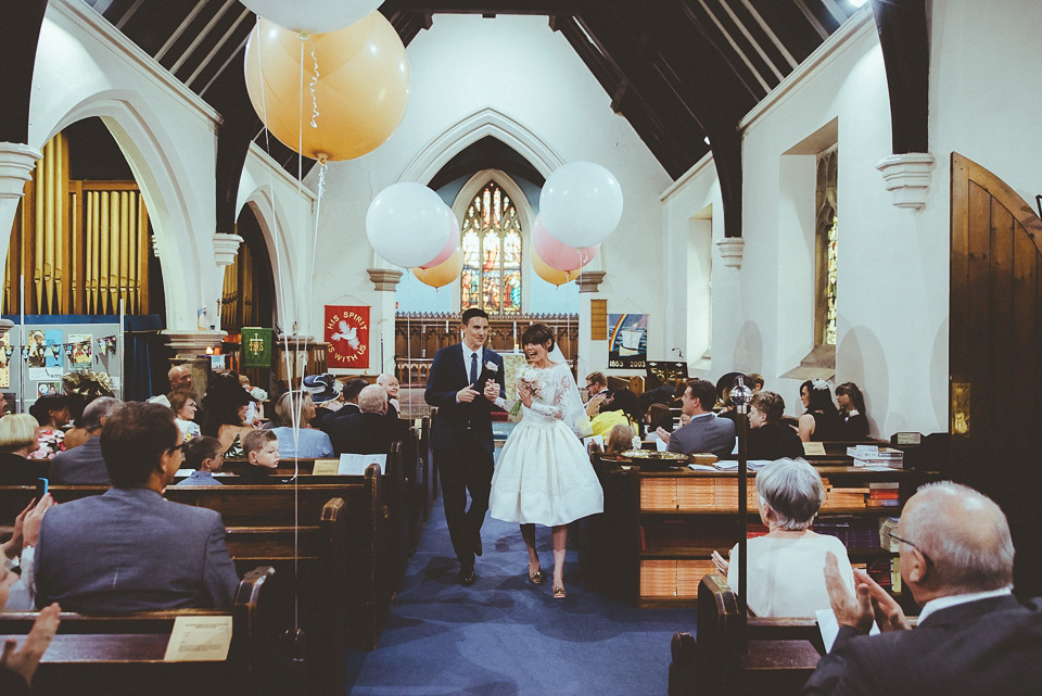 The bride wears a 1950's inspired lace dress for her village hall wedding in Yorkshire. Photography by Shutter Go Click.