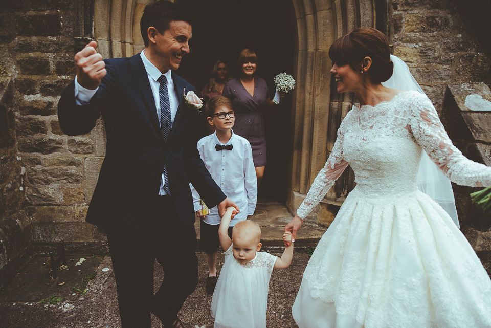 The bride wears a 1950's inspired lace dress for her village hall wedding in Yorkshire. Photography by Shutter Go Click.