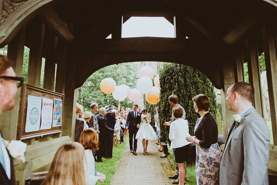 The bride wears a 1950's inspired lace dress for her village hall wedding in Yorkshire. Photography by Shutter Go Click.