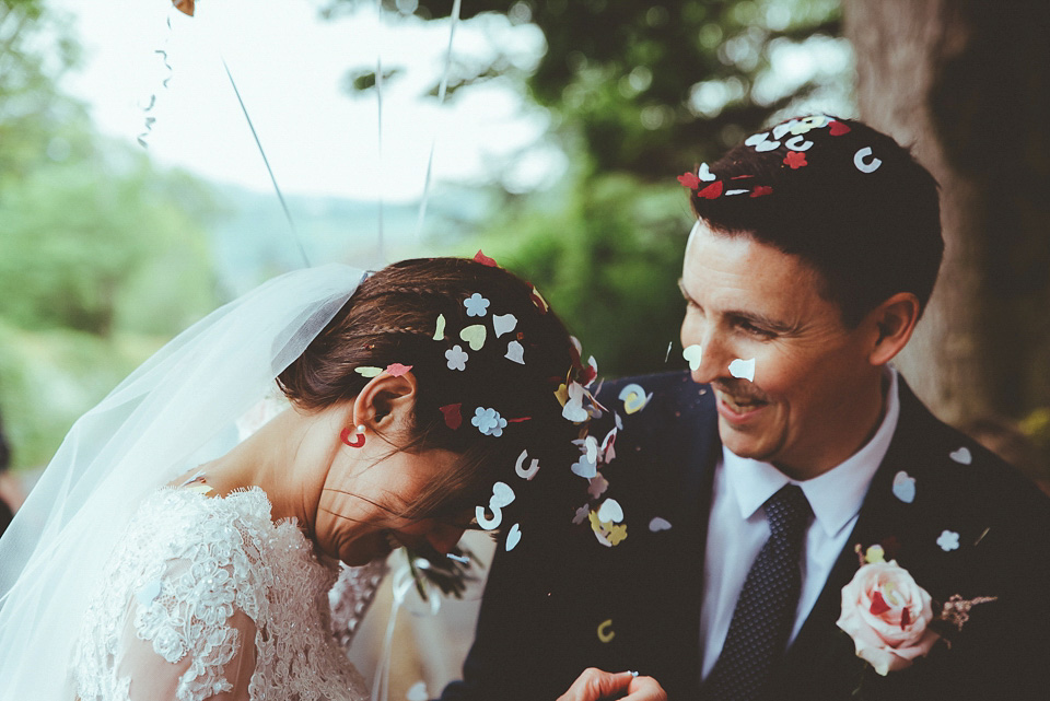 The bride wears a 1950's inspired lace dress for her village hall wedding in Yorkshire. Photography by Shutter Go Click.