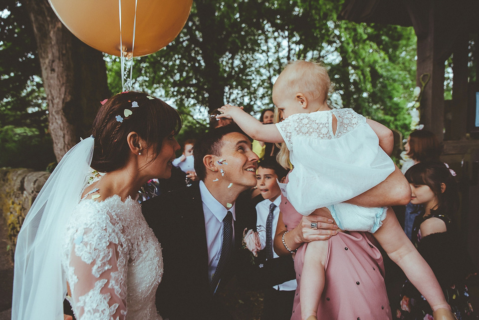 The bride wears a 1950's inspired lace dress for her village hall wedding in Yorkshire. Photography by Shutter Go Click.