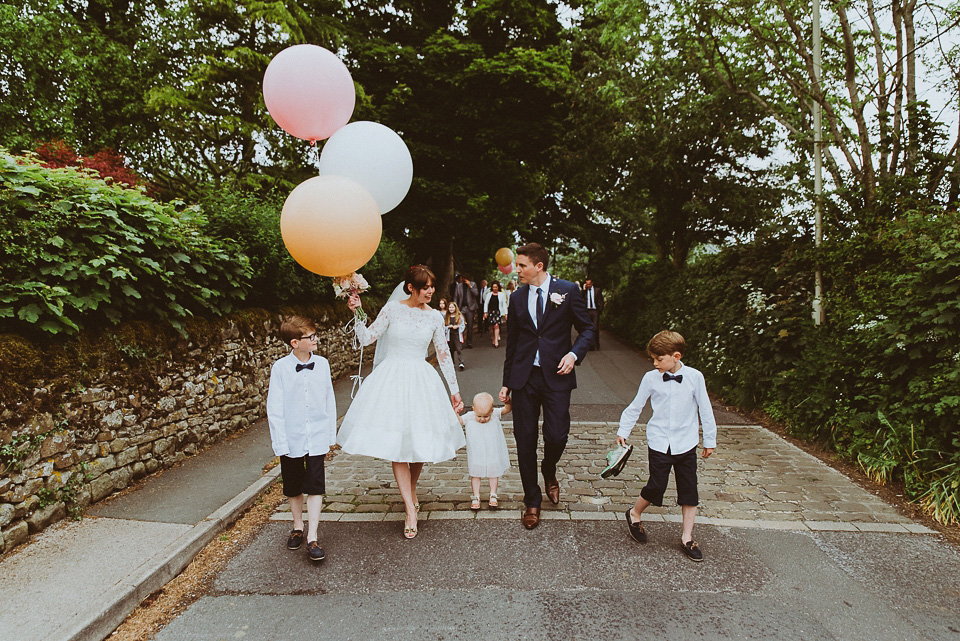 The bride wears a 1950's inspired lace dress for her village hall wedding in Yorkshire. Photography by Shutter Go Click.