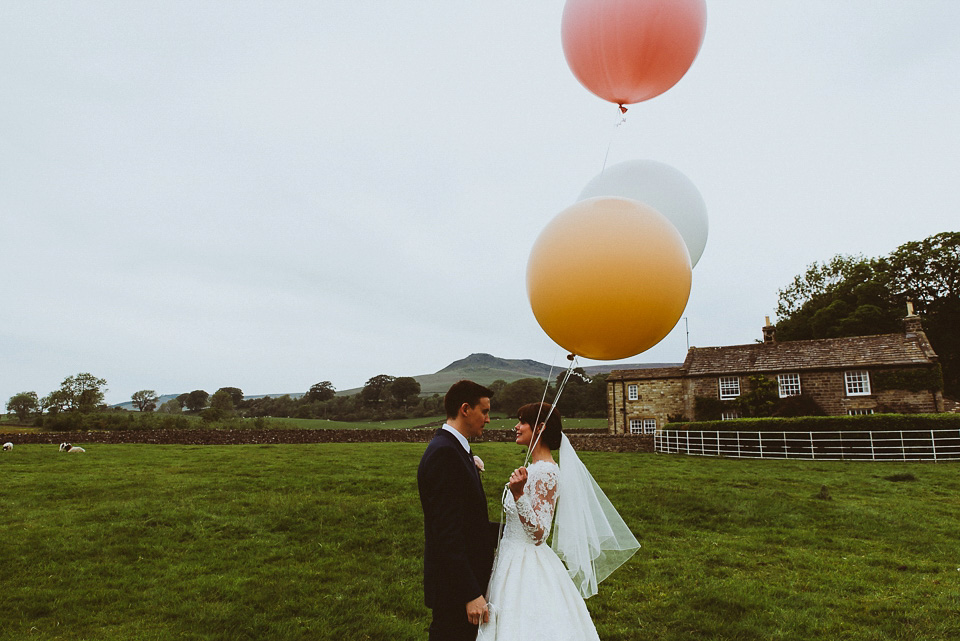 The bride wears a 1950's inspired lace dress for her village hall wedding in Yorkshire. Photography by Shutter Go Click.