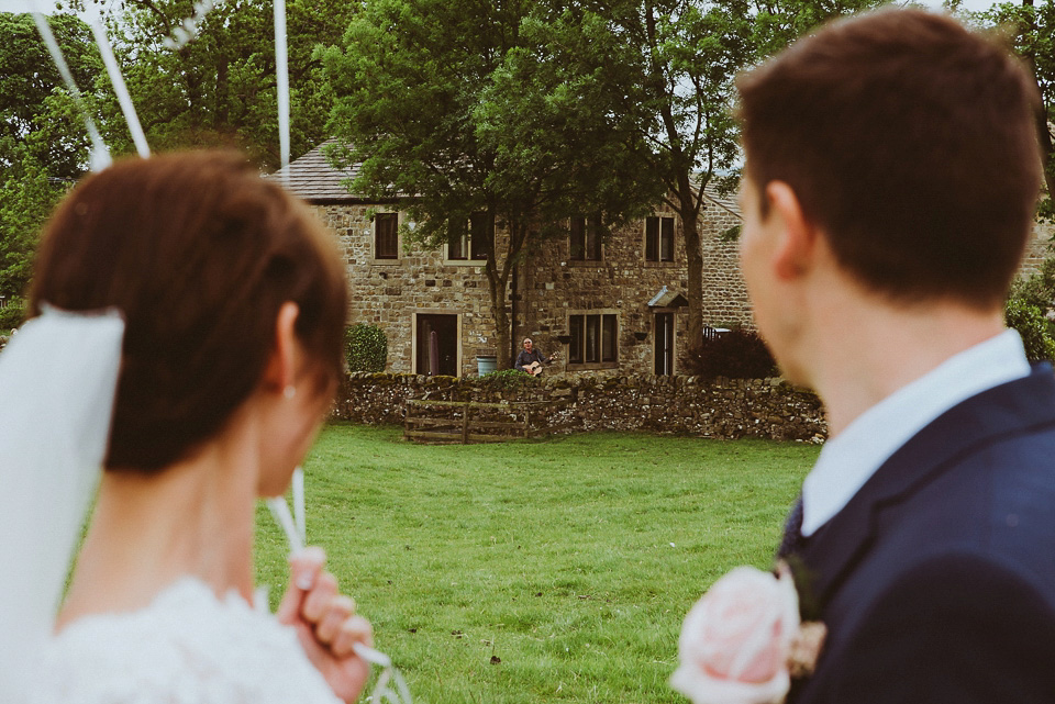 The bride wears a 1950's inspired lace dress for her village hall wedding in Yorkshire. Photography by Shutter Go Click.