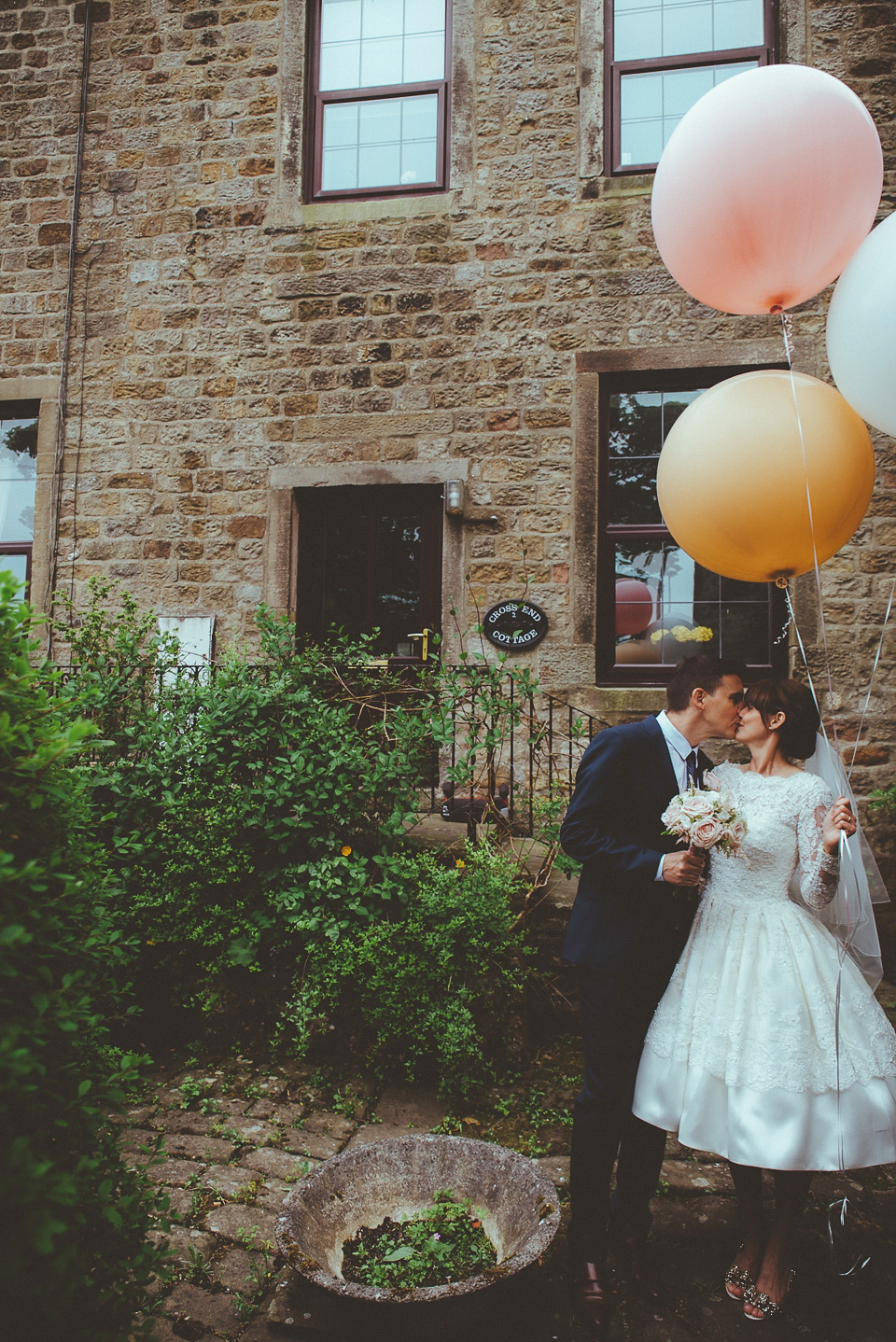 The bride wears a 1950's inspired lace dress for her village hall wedding in Yorkshire. Photography by Shutter Go Click.