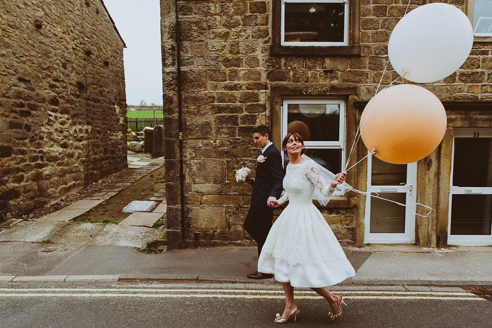 The bride wears a 1950's inspired lace dress for her village hall wedding in Yorkshire. Photography by Shutter Go Click.