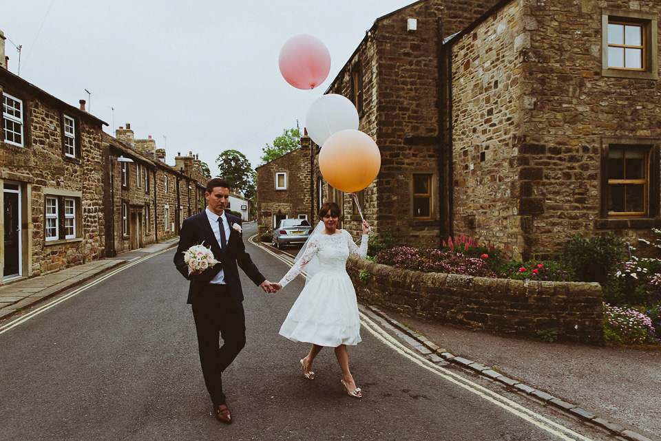 The bride wears a 1950's inspired lace dress for her village hall wedding in Yorkshire. Photography by Shutter Go Click.