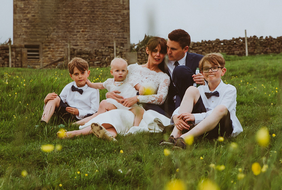 The bride wears a 1950's inspired lace dress for her village hall wedding in Yorkshire. Photography by Shutter Go Click.