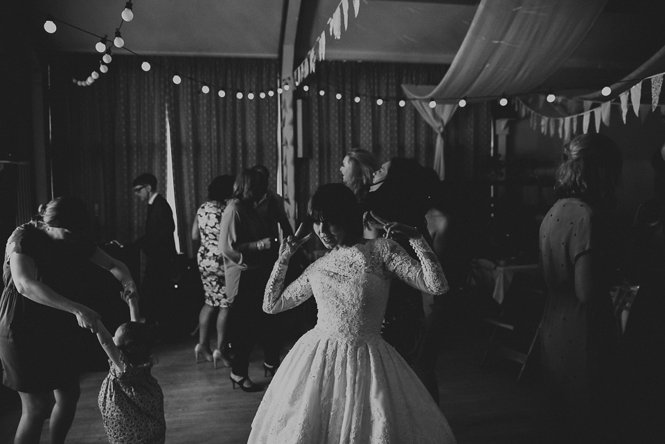 The bride wears a 1950's inspired lace dress for her village hall wedding in Yorkshire. Photography by Shutter Go Click.