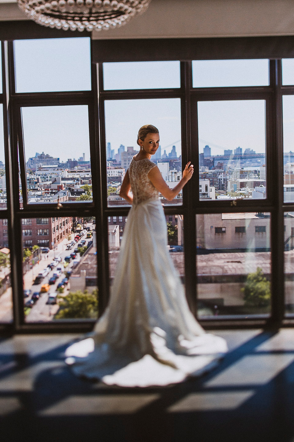 The bride wears Mori Lee for her glamorous rooftop New York wedding. Photography by Forged In The North
