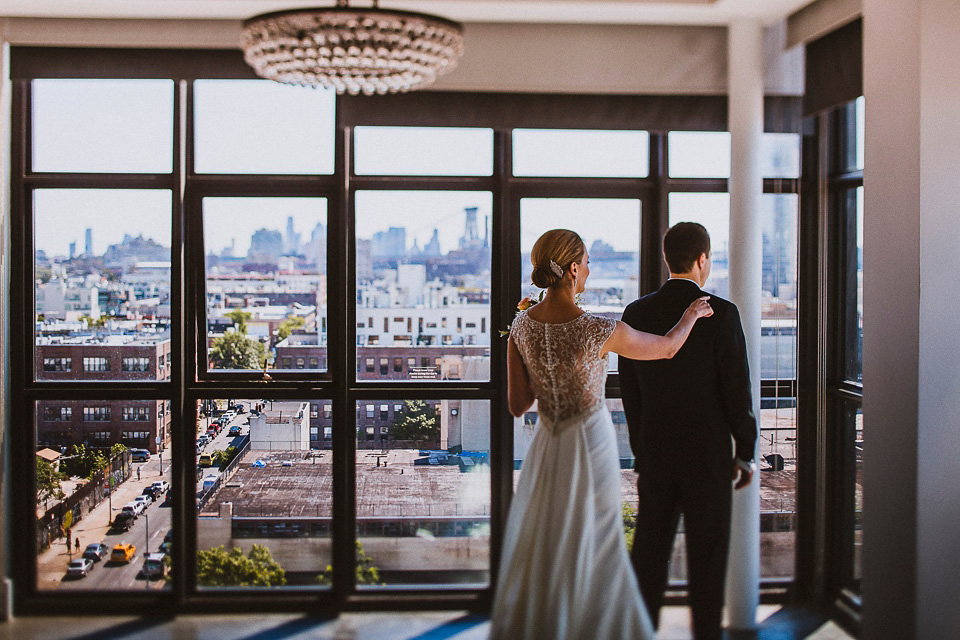 The bride wears Mori Lee for her glamorous rooftop New York wedding. Photography by Forged In The North