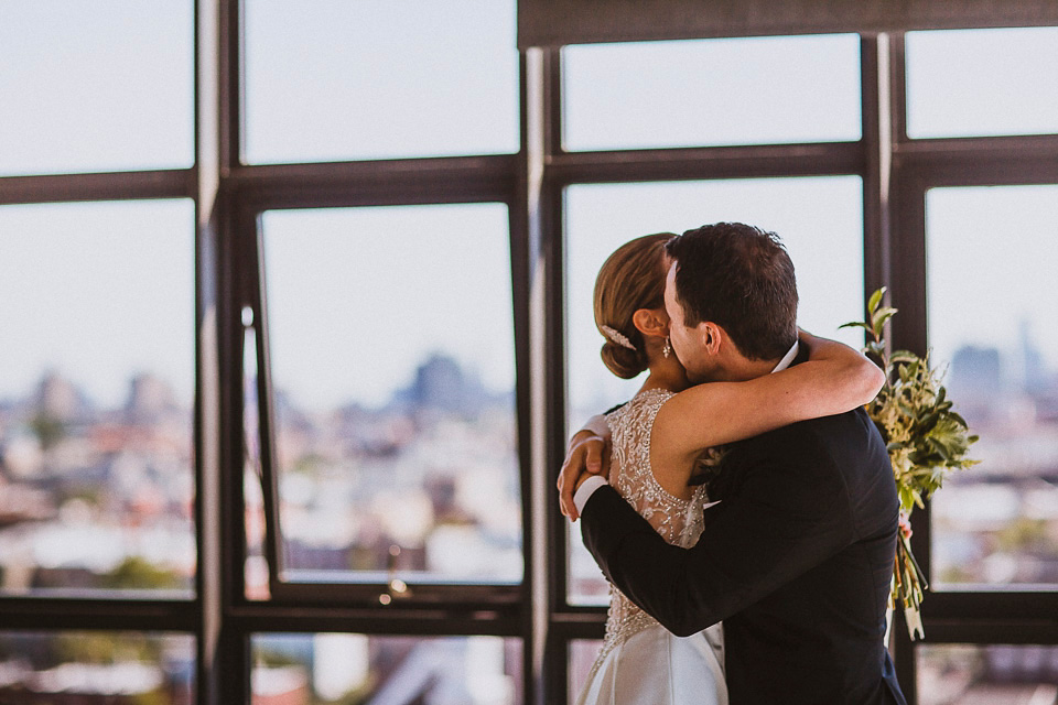 The bride wears Mori Lee for her glamorous rooftop New York wedding. Photography by Forged In The North