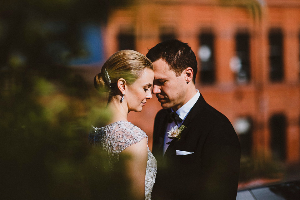 The bride wears Mori Lee for her glamorous rooftop New York wedding. Photography by Forged In The North