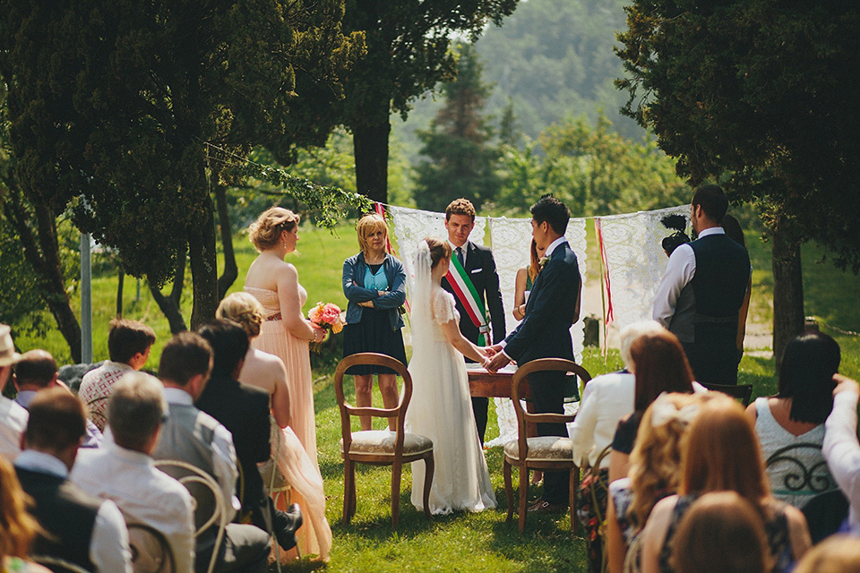 The bride wears Grace Loves Lace for her laid back, rustic, simple and elegant outdoor wedding in the Italian hillsides. Photography by Peter Jurica, film by Happy Wedding Films.