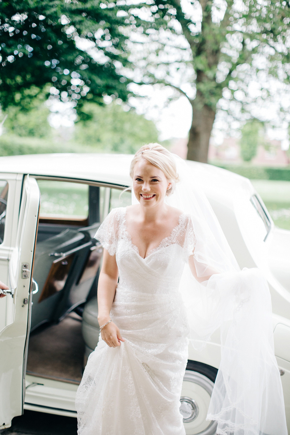 The bride wears Suzanne Neville for her Summer wedding at a vintage railway station. Images by M&J Photography.