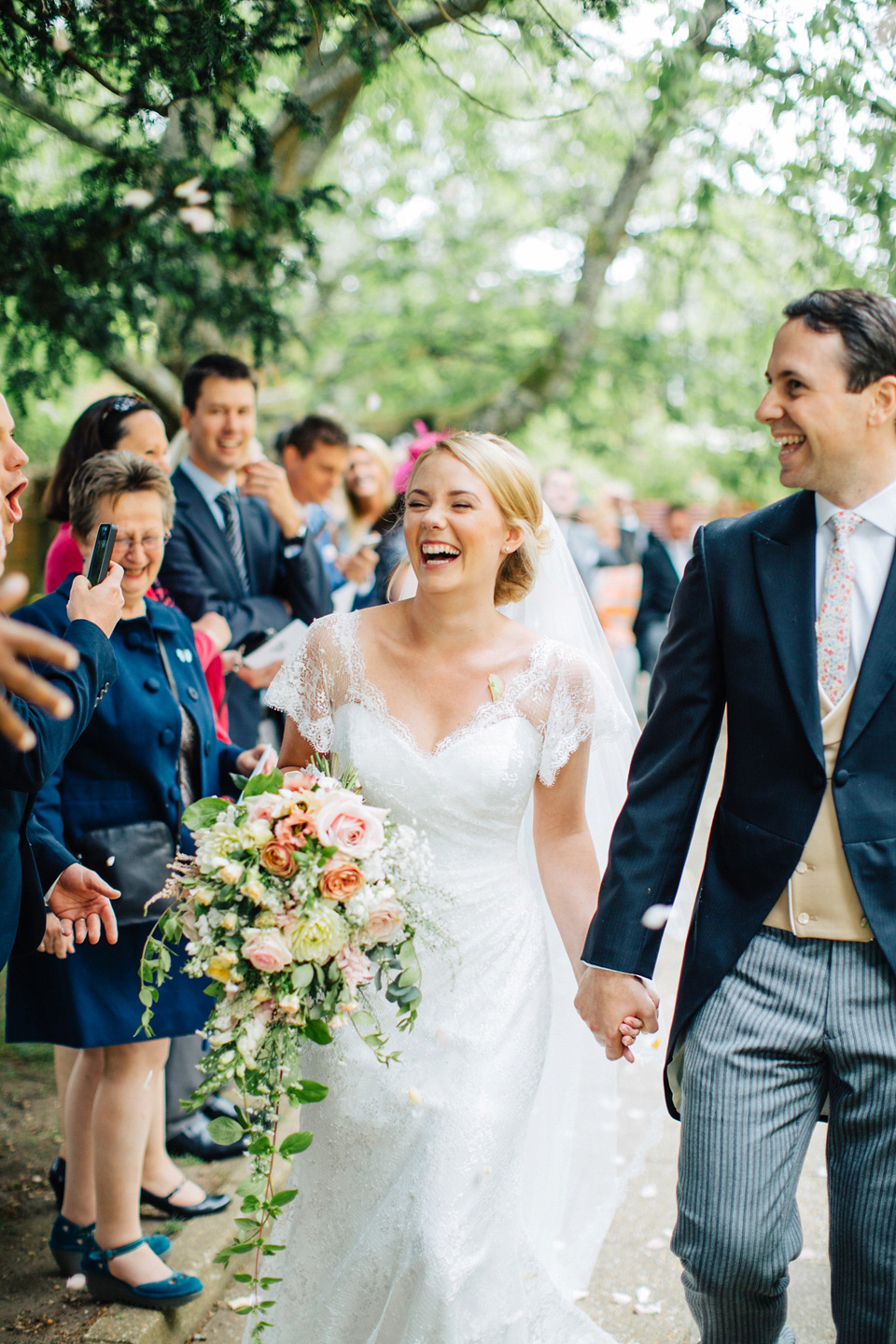 The bride wears Suzanne Neville for her Summer wedding at a vintage railway station. Images by M&J Photography.