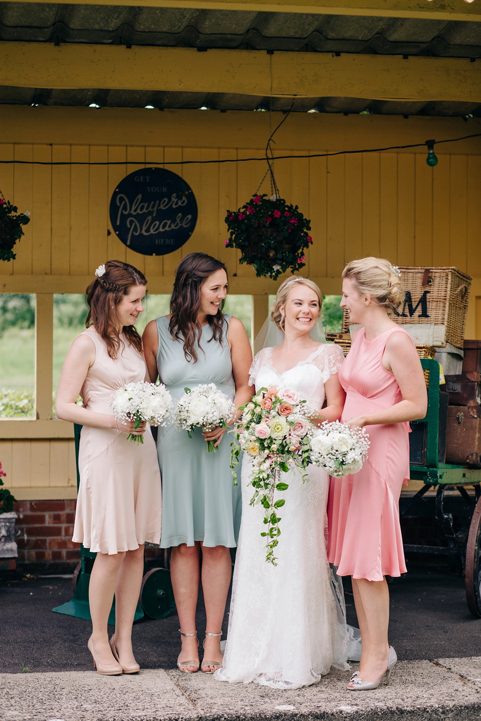 The bride wears Suzanne Neville for her Summer wedding at a vintage railway station. Images by M&J Photography.