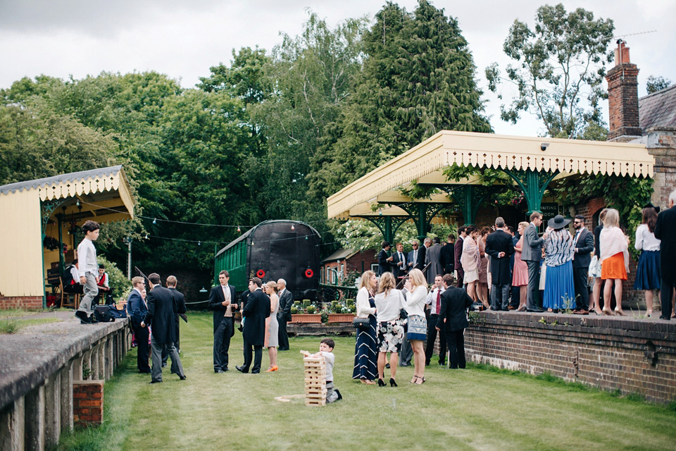 The bride wears Suzanne Neville for her Summer wedding at a vintage railway station. Images by M&J Photography.