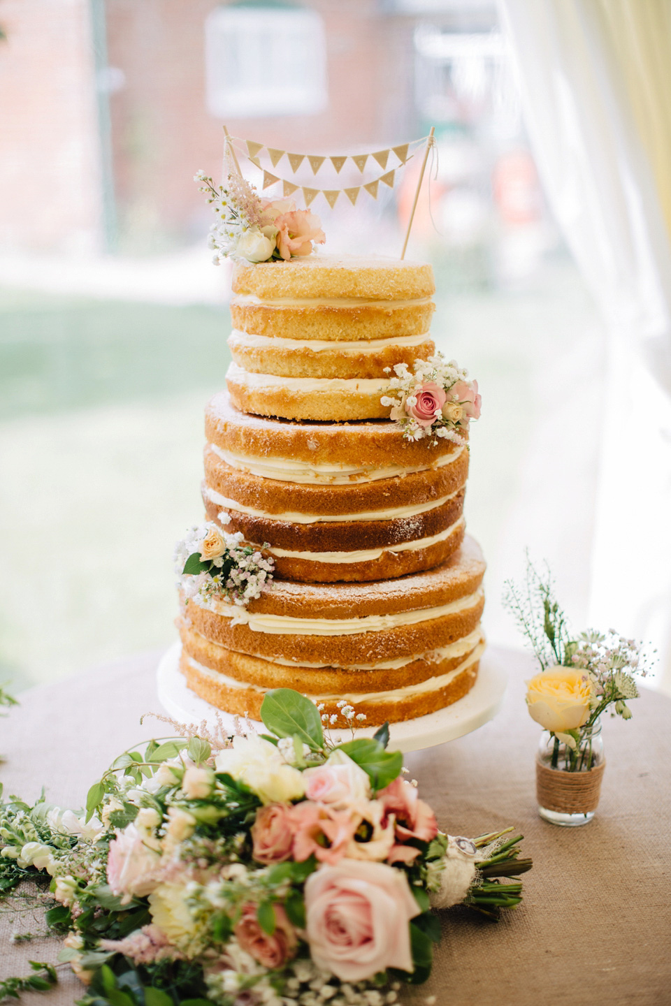 The bride wears Suzanne Neville for her Summer wedding at a vintage railway station. Images by M&J Photography.