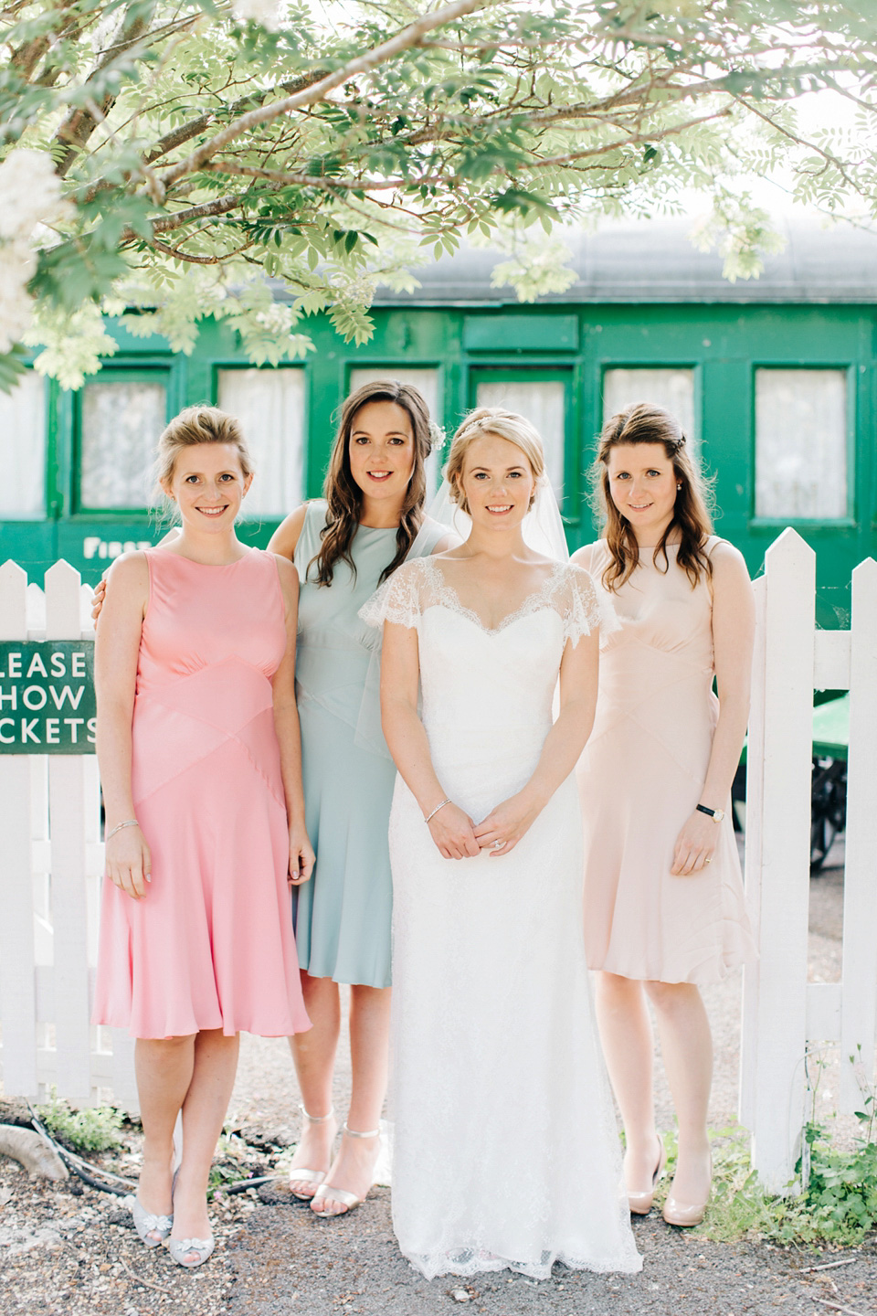 The bride wears Suzanne Neville for her Summer wedding at a vintage railway station. Images by M&J Photography.