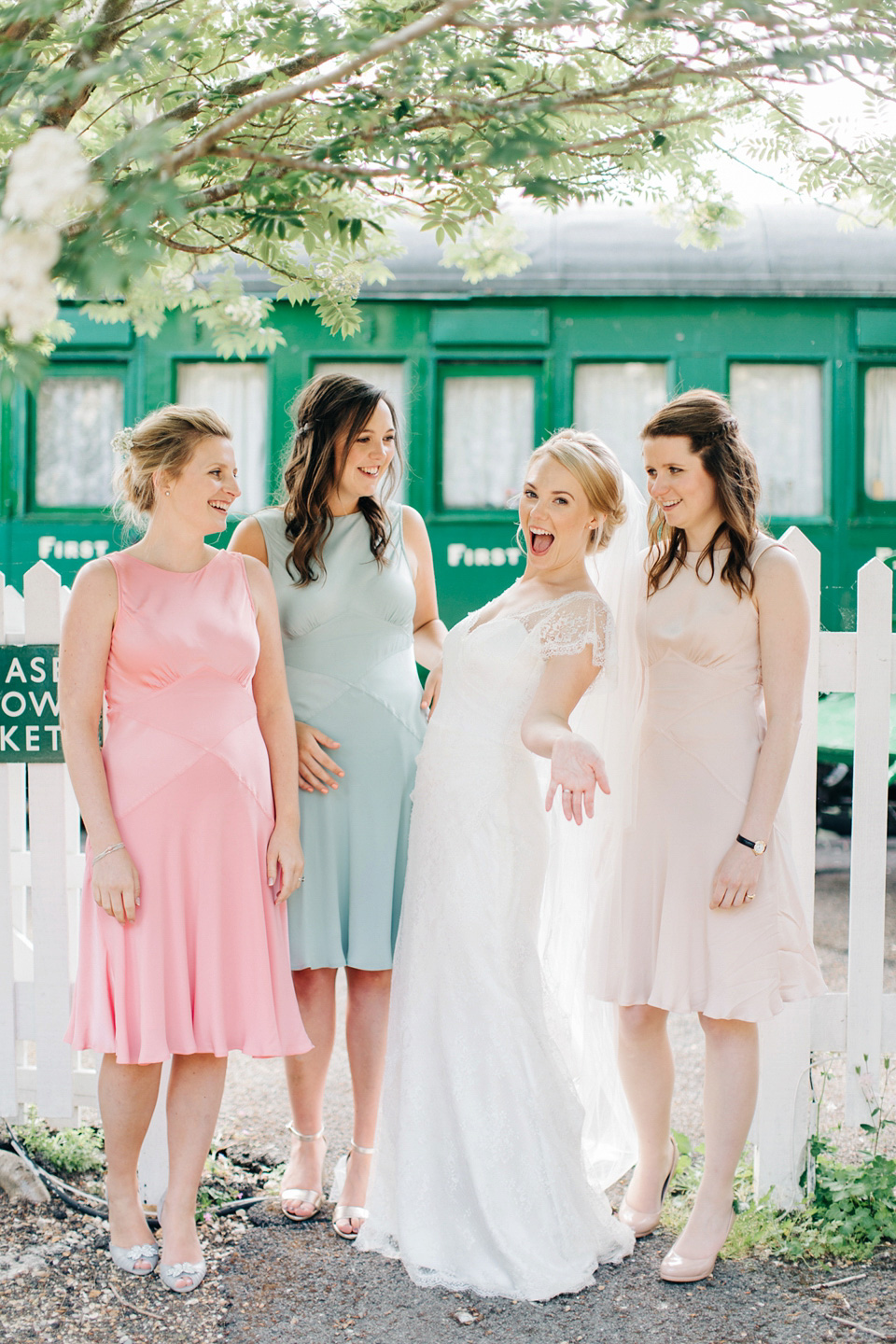 The bride wears Suzanne Neville for her Summer wedding at a vintage railway station. Images by M&J Photography.