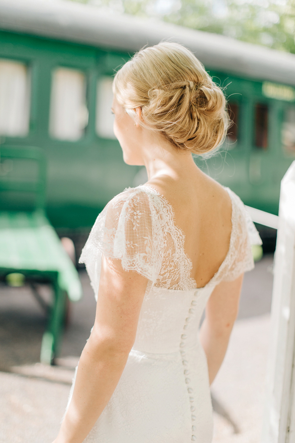 The bride wears Suzanne Neville for her Summer wedding at a vintage railway station. Images by M&J Photography.