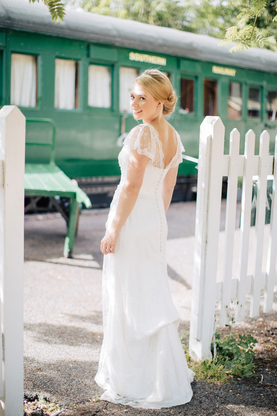 The bride wears Suzanne Neville for her Summer wedding at a vintage railway station. Images by M&J Photography.