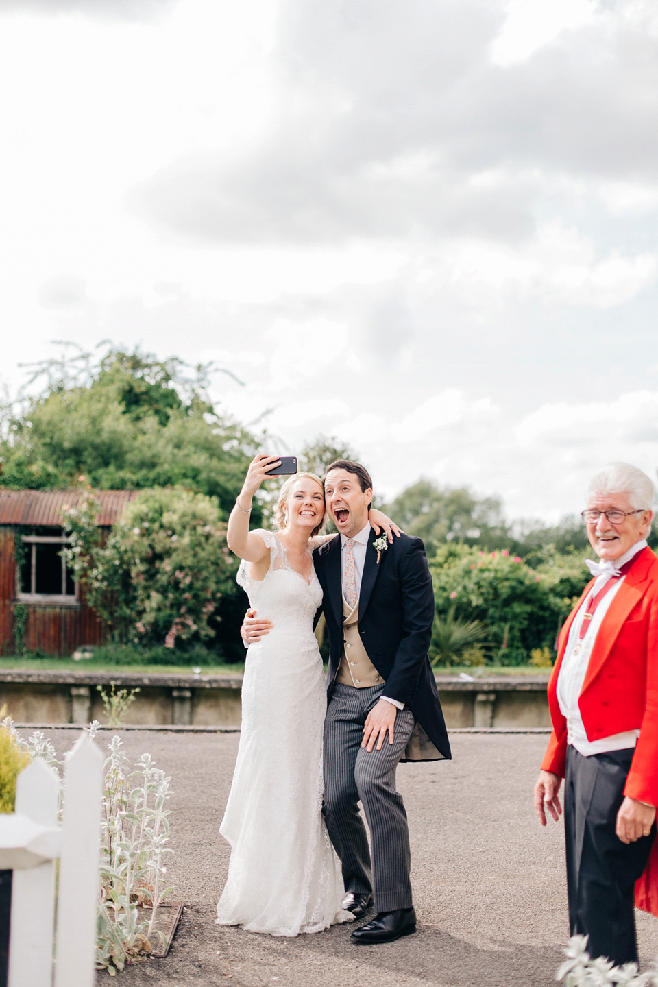 The bride wears Suzanne Neville for her Summer wedding at a vintage railway station. Images by M&J Photography.