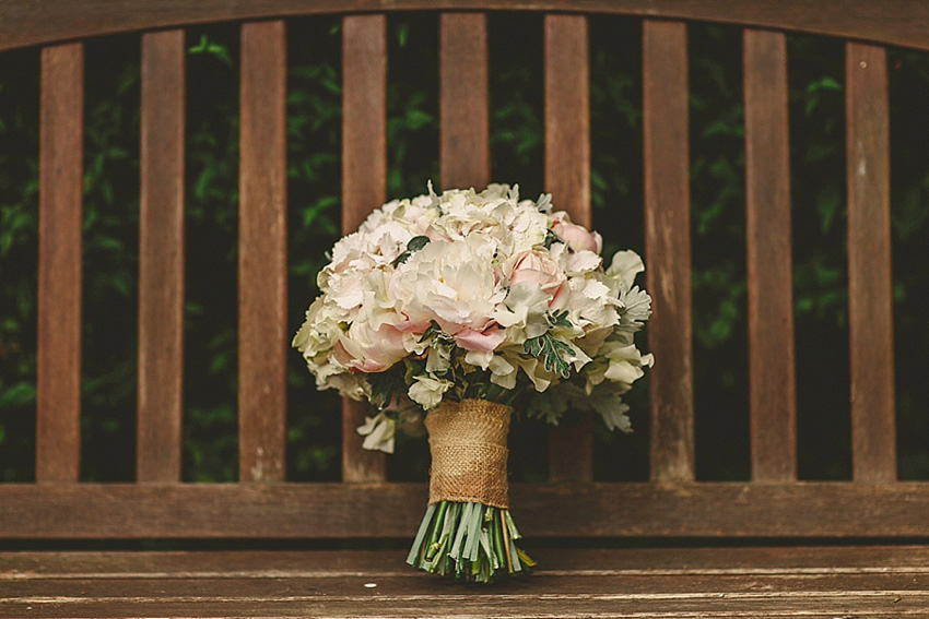 The bride wore a Watters wedding dress for her wedding at The Great Barn at Micklefield Hall in Hertfordshire. The bridesmaids wore navy blue. Photography by Benjamin Stuart.