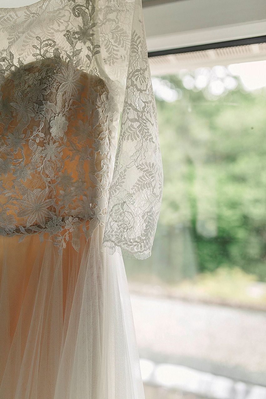 The bride wore a Watters wedding dress for her wedding at The Great Barn at Micklefield Hall in Hertfordshire. The bridesmaids wore navy blue. Photography by Benjamin Stuart.