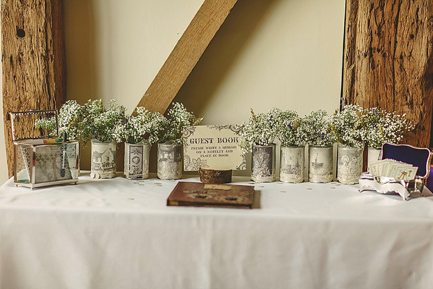 The bride wore a Watters wedding dress for her wedding at The Great Barn at Micklefield Hall in Hertfordshire. The bridesmaids wore navy blue. Photography by Benjamin Stuart.