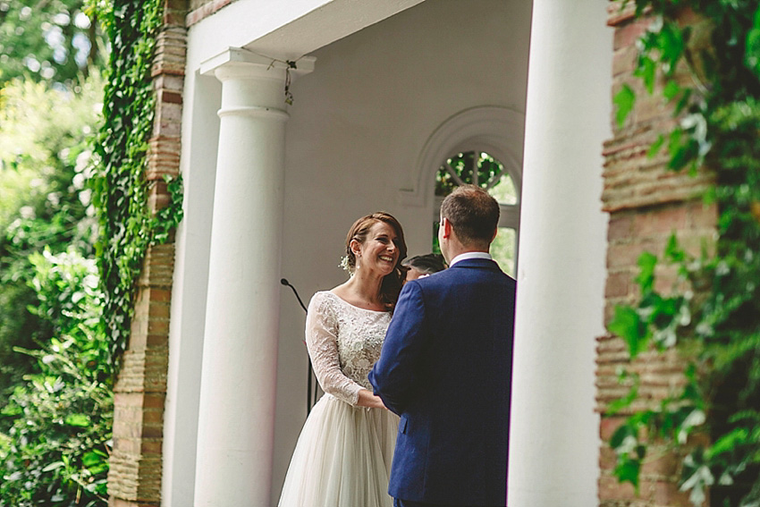 The bride wore a Watters wedding dress for her wedding at The Great Barn at Micklefield Hall in Hertfordshire. The bridesmaids wore navy blue. Photography by Benjamin Stuart.