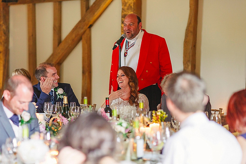 The bride wore a Watters wedding dress for her wedding at The Great Barn at Micklefield Hall in Hertfordshire. The bridesmaids wore navy blue. Photography by Benjamin Stuart.